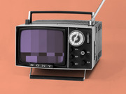 Vintage Sony portable television with antenna on an orange background, screen showing pixelated static bars in purple tones.