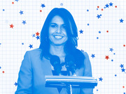 Blue-tinted editorial illustration of a smiling woman at a podium with microphones, surrounded by red and blue stars on a grid background.