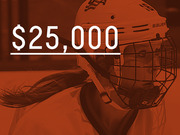 Editorial infographic showing $25,000 in large white text overlaid on a red-tinted photo of a female ice hockey player wearing a Bauer helmet.