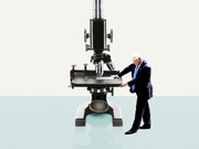 Editorial illustration showing a small figure of Donald Trump placing a slide on an oversized microscope, suggesting scrutiny or examination.