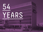 Purple-tinted photo of a large government building overlaid with large white text reading 54 Years, referencing the duration of US-Cuba diplomatic estrangement.