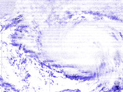 Satellite or radar image showing a large swirling storm system in blue and white tones with a visible eye-like clear center.