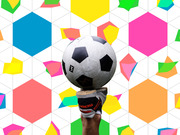 A soccer ball balanced on a Nike Tiempo cleat held aloft against a colorful geometric hexagon pattern background.