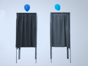 Two voting booths with dark curtains, each topped with a blue balloon, against a light gray background.