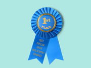 A blue first-place ribbon award with gold text reading 1st Place and a ribbon tail labeled Most Popular Above Replacement Governor.