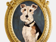 A painted portrait of a terrier dog wearing a black collar, displayed in an ornate oval gold frame.
