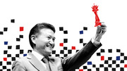 Editorial illustration of a smiling man in a suit raising a red chess king piece, surrounded by scattered black, red, and blue squares on a white background.