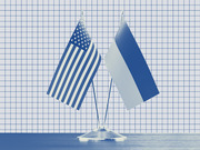 Blue-tinted editorial illustration of US and Russian flags on a shared desk stand against a grid-paper background.