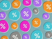 Decorative editorial illustration featuring colorful blob shapes in teal, orange, pink, purple, and gray, each displaying a white percent sign.