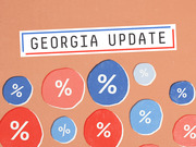 Editorial illustration for a Georgia election update featuring red and blue circles with percentage signs on a tan background.