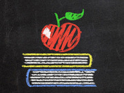 Chalk-style drawing of a red apple sitting on top of a stack of colorful books on a dark chalkboard background.