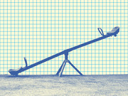 A blue-tinted photo of a playground seesaw set against a yellow grid-paper background, used as editorial illustration.