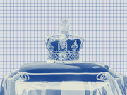 Blue-tinted editorial photo illustration of a jeweled royal crown resting on a cushion, overlaid with a grid pattern background.
