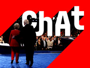 Editorial graphic with the word CHAT in large white letters overlaid on a photo of two debate candidates on a blue stage, framed by red and black geometric shapes.