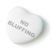 A white candy heart with the phrase NO BLUFFING printed on it in gray text, styled like a Valentine's Day conversation heart.