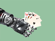A robotic mechanical arm holding a fan of playing cards including three kings and an ace of clubs against a green background.