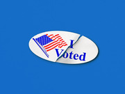 An I Voted sticker featuring an American flag torn in two, set against a blue background, used as editorial illustration.