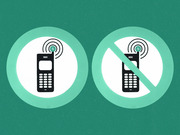 Two circular icons on a teal background showing a mobile phone allowed on the left and a mobile phone prohibited (with a slash) on the right.