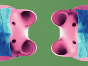 Stylized editorial illustration of two mirrored pink video game controllers wearing blue face masks on a green background.