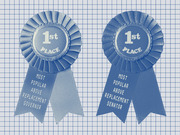 Two blue first-place ribbons on a grid background, labeled Most Popular Above Replacement Governor and Most Popular Above Replacement Senator.