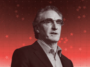 Stylized editorial portrait of a man in glasses and suit jacket against a red background with star decorations, rendered in black and white with red tones.
