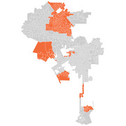 A choropleth-style map showing census tracts or precincts in an urban area, with selected regions highlighted in orange against a gray background.