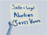 A blue-tinted editorial illustration of a hand holding a protest sign reading Safe + Legal Abortion Saves Women against a grid paper background.
