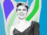 Black and white photo of a smiling woman with short hair set against a colorful abstract background with blue, green, and purple shapes.