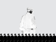 Black and white editorial illustration showing a large police officer figure from behind towering over a row of smaller uniformed officers at the bottom.