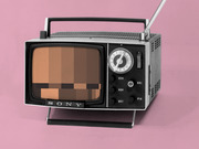 A vintage Sony portable television with a pixelated skin-tone color bar pattern on its screen, set against a pink background.
