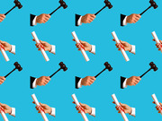 Repeating pattern on a blue background of hands holding judge's gavels and hands holding rolled diplomas tied with red ribbon.