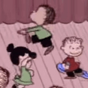 Cartoon illustration of Peanuts characters Lucy, Linus, and another child dancing, in classic Charles Schulz animation style.