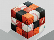 A Rubik's cube illustrated with panels showing various sports balls including baseballs, basketballs, footballs, and black squares.