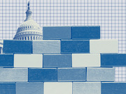 Blue-tinted editorial illustration showing a brick wall in front of the US Capitol building on a grid background, symbolizing political obstruction or a government shutdown.