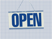 An illustrated OPEN sign hanging by a chain against a blue grid paper background, rendered in blue and white tones.