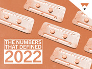 Editorial illustration showing multiple blister packs of pills in an orange duotone style with the text The Numbers That Defined 2022.