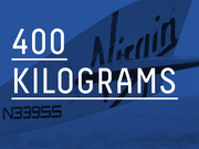 Editorial infographic displaying the quantity 400 kilograms in large white text over a blue-tinted photo of a Virgin aircraft tail.