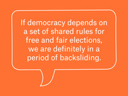 Orange speech bubble graphic with white text quoting a statement about democracy backsliding and free and fair elections.