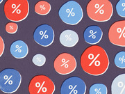 Decorative editorial illustration featuring red and blue circles of varying sizes with white percentage signs on a dark purple background.