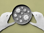 Paper-cut style illustration of gloved hands holding a petri dish containing multiple coronavirus particle icons on a green background.