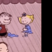 Cartoon still from a Peanuts animation showing Linus and Sally dancing on a stage with rain in the background.