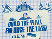 Blue-tinted editorial photo illustration of a person holding a protest sign reading Build The Wall Enforce The Law with American flags and a grid background.